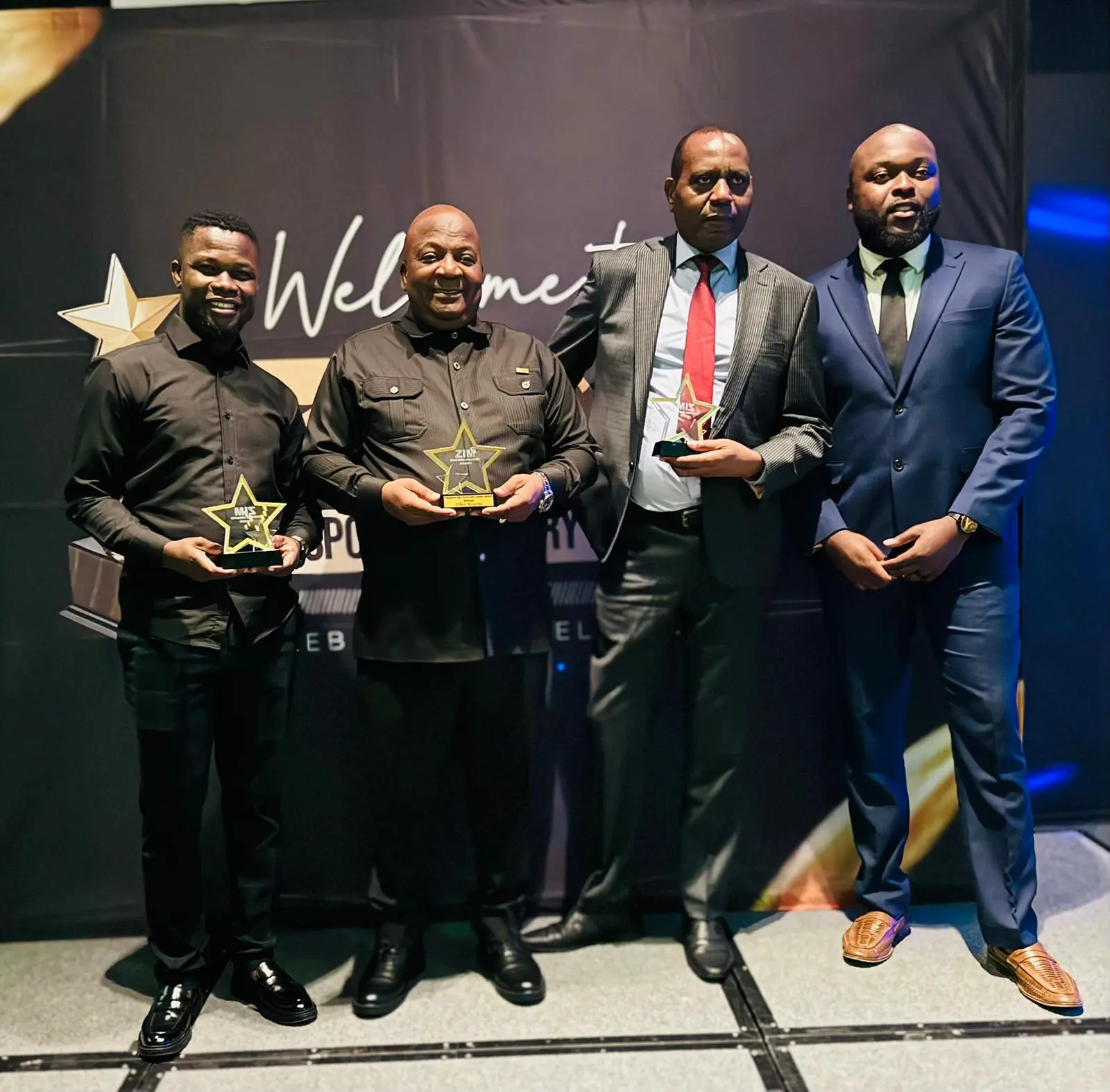 Abel Mavura with fellow awardees holding their awards